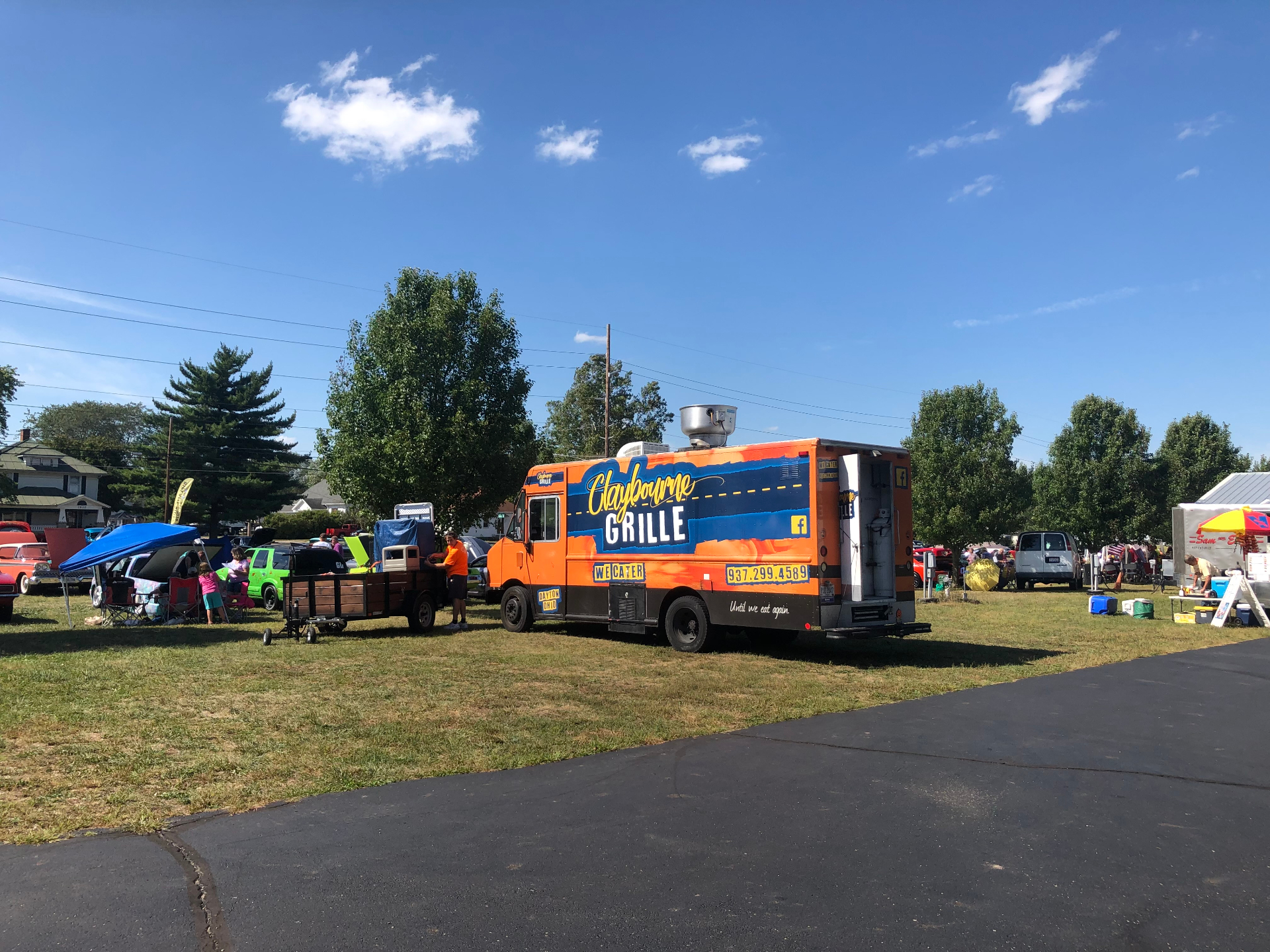 Claybourne Grille orange food truck at a community event